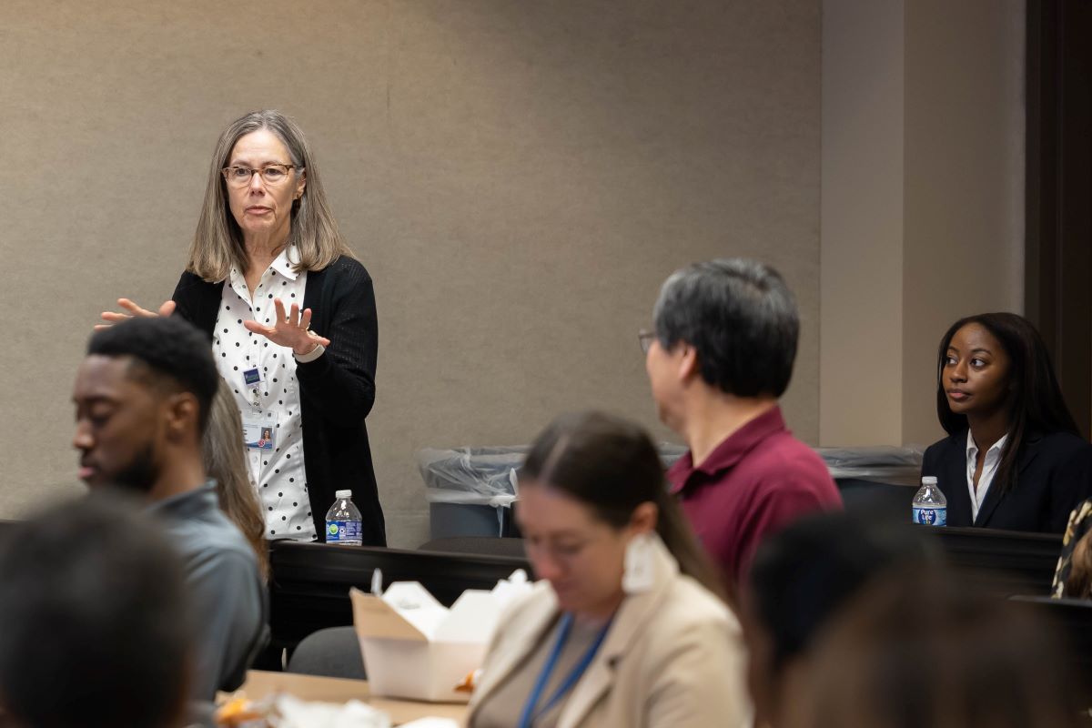 Dr. Mary Currier standing and speaking in the audience at the 2023 SOPH Research Day